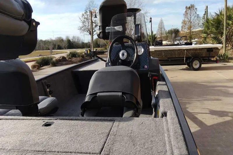 Slide: The Image of 2026 Tracker Bass Tracker Classic XL boat interior with steering wheel and seating. - 3