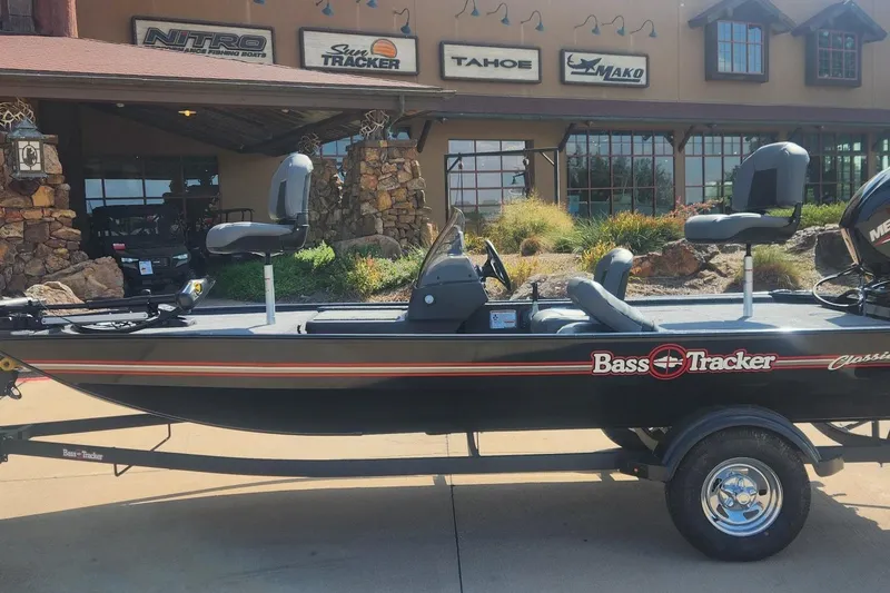 Slide: The Image of 2026 Tracker Bass Tracker Classic XL boat displayed outside dealership. - 6