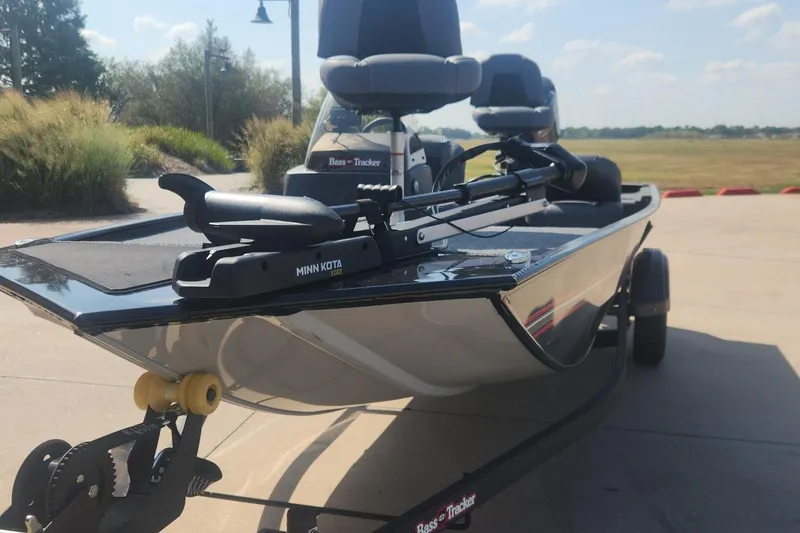 Slide: The Image of 2026 Tracker Bass Tracker Classic XL boat with Minn Kota motor on trailer. - 8