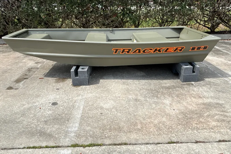 The Image of 2026 Tracker Grizzly 10 Jon boat on concrete blocks, outdoor setting. - 0