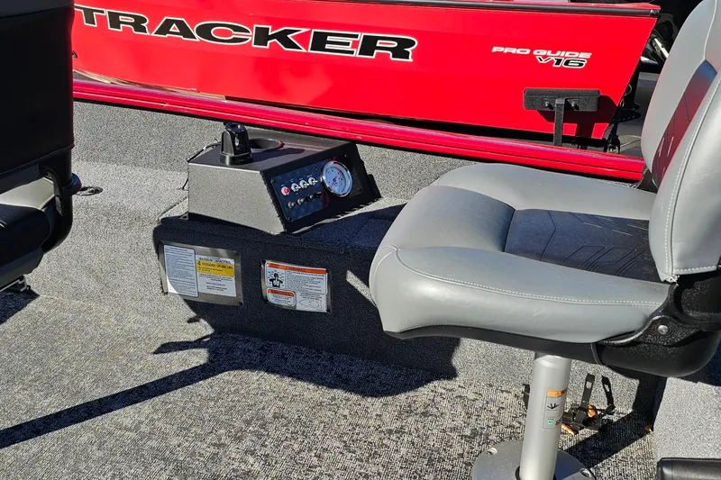 Slide: The Image of Interior of 2026 Tracker Super Guide V-16 T boat with seating and control panel. - 18