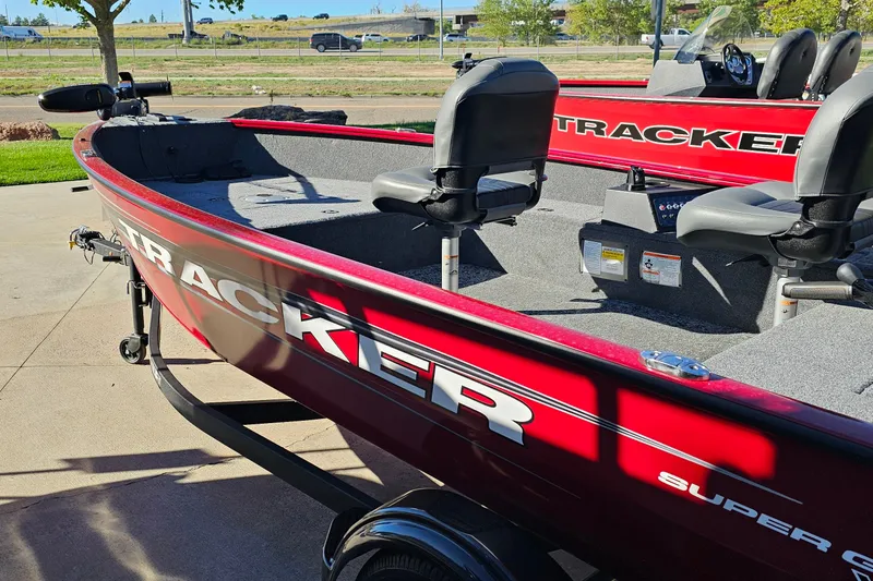 Slide: The Image of 2026 Tracker Super Guide V-16 T boat, red exterior, parked outdoors. - 16