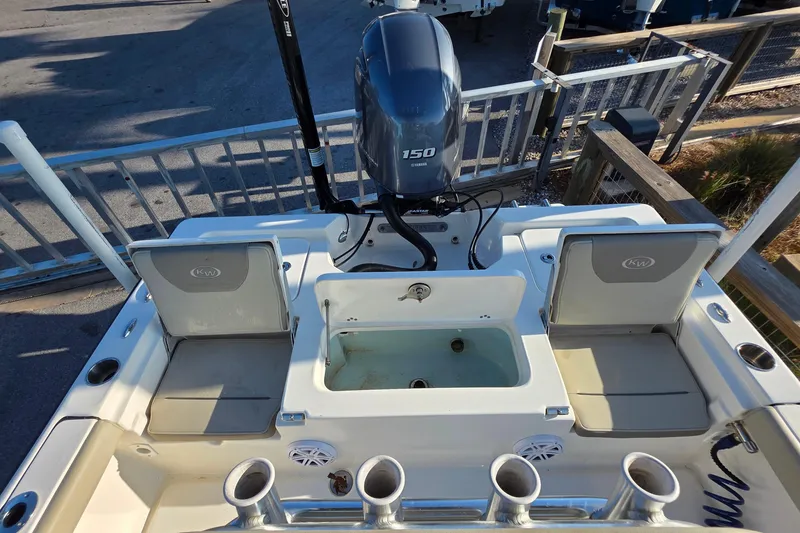 Slide: The Image of 2023 Key West 210 Bay Reef boat with Yamaha 150 engine, featuring seating and storage compartments. - 11