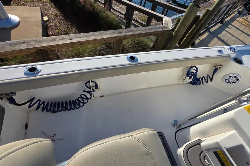 Slide: The Image of 2023 Key West 210 Bay Reef boat interior with coiled hose and seating. - 13