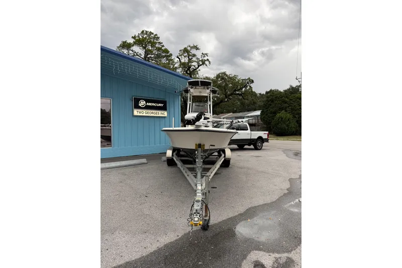 Slide: The Image of 2023 Key West 210 Bay Reef boat on trailer outside Two Georges Inc. building. - 2