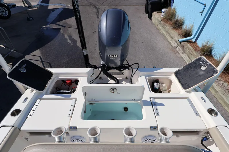 Slide: The Image of 2023 Key West 210 Bay Reef boat with Yamaha 150 engine and storage compartments. - 22