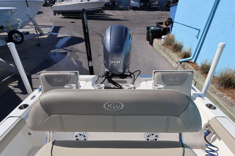 Slide: The Image of 2023 Key West 210 Bay Reef boat with Yamaha 150 engine at a marina. - 24