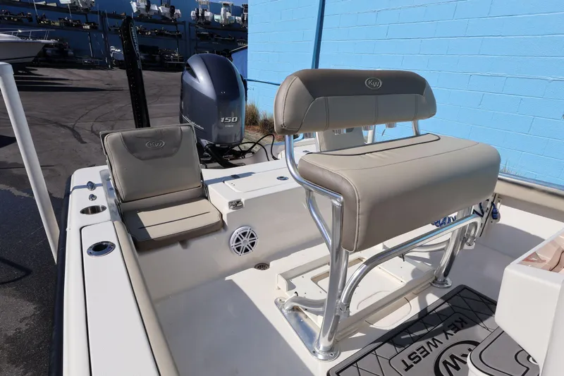 Slide: The Image of 2023 Key West 210 Bay Reef boat interior with seating and motor. - 25