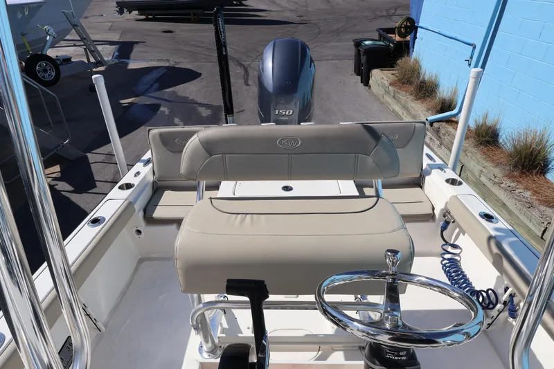 Slide: The Image of 2023 Key West 210 Bay Reef boat interior with steering wheel and seating. - 27