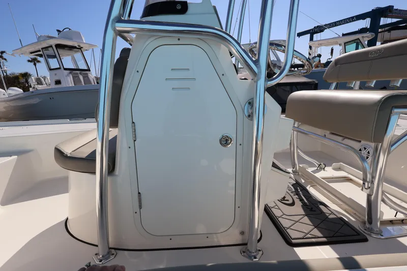 Slide: The Image of 2023 Key West 210 Bay Reef boat interior with seating and storage compartment. - 28
