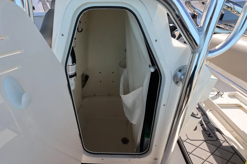 Slide: The Image of 2023 Key West 210 Bay Reef boat storage compartment with open door and fire extinguisher. - 30