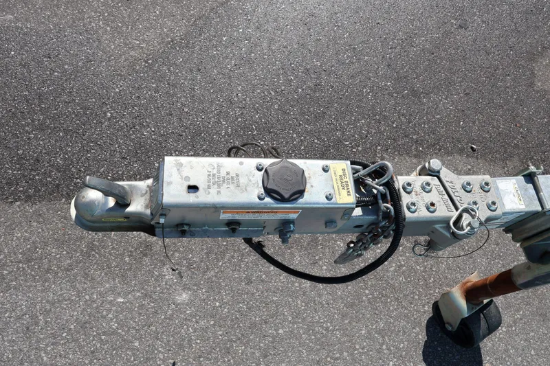 Slide: The Image of Trailer hitch of a 2023 Key West 210 Bay Reef on asphalt surface. - 36