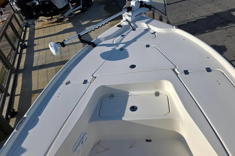 Slide: The Image of 2023 Key West 210 Bay Reef boat deck with storage compartments and trolling motor. - 4