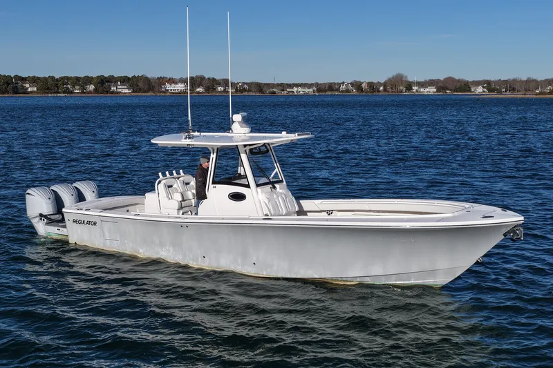 The Image of 2021 Regulator 34 boat on calm water, featuring twin engines and sleek design. - 0