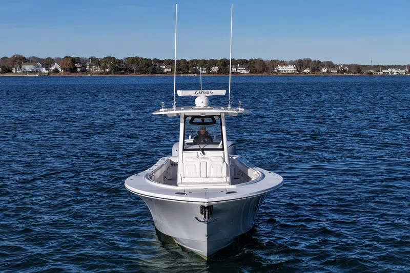 Slide: The Image of 2021 Regulator 34 boat on calm water with coastal background. - 10