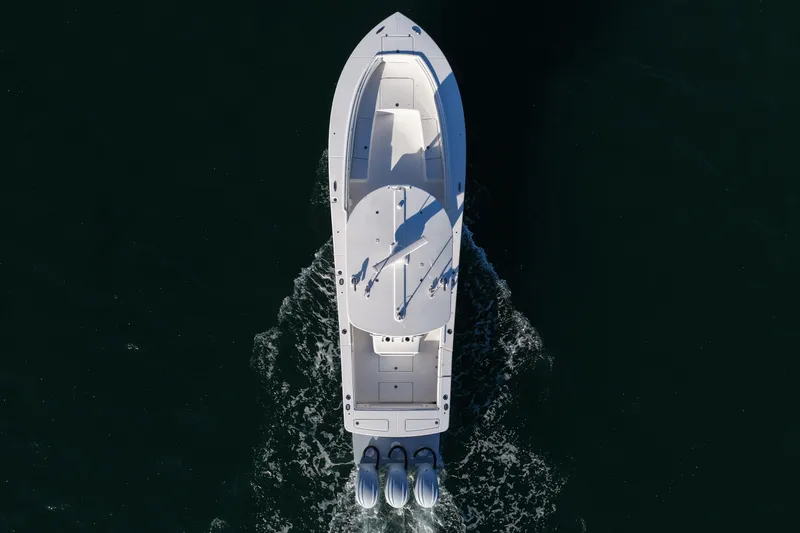 Slide: The Image of Aerial view of 2021 Regulator 34 boat cruising on dark water. - 17