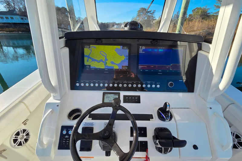 Slide: The Image of 2021 Regulator 34 boat dashboard with navigation screens and steering wheel. - 22