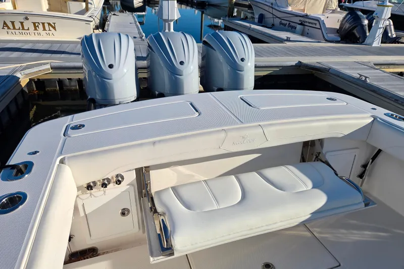 Slide: The Image of 2021 Regulator 34 boat with triple outboard engines docked at marina. - 29