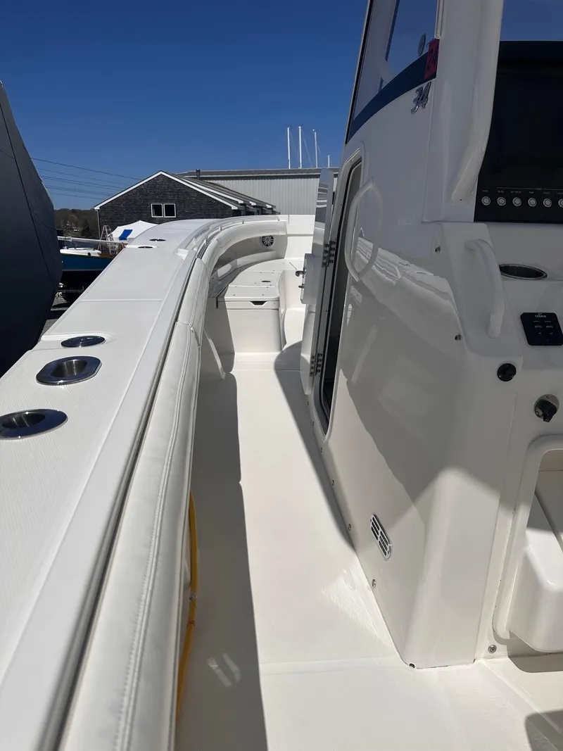Slide: The Image of 2021 Regulator 34 boat deck with sleek white design and modern controls. - 30