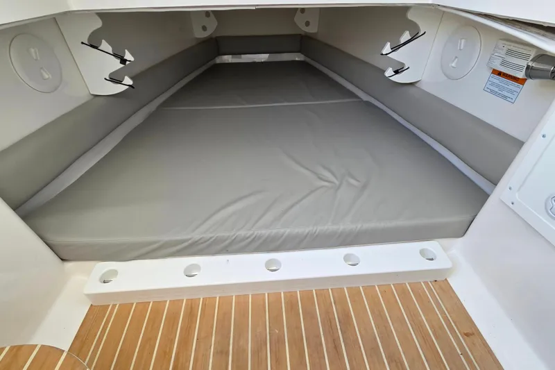 Slide: The Image of 2021 Regulator 34 boat cabin interior with cushioned seating and wood flooring. - 36
