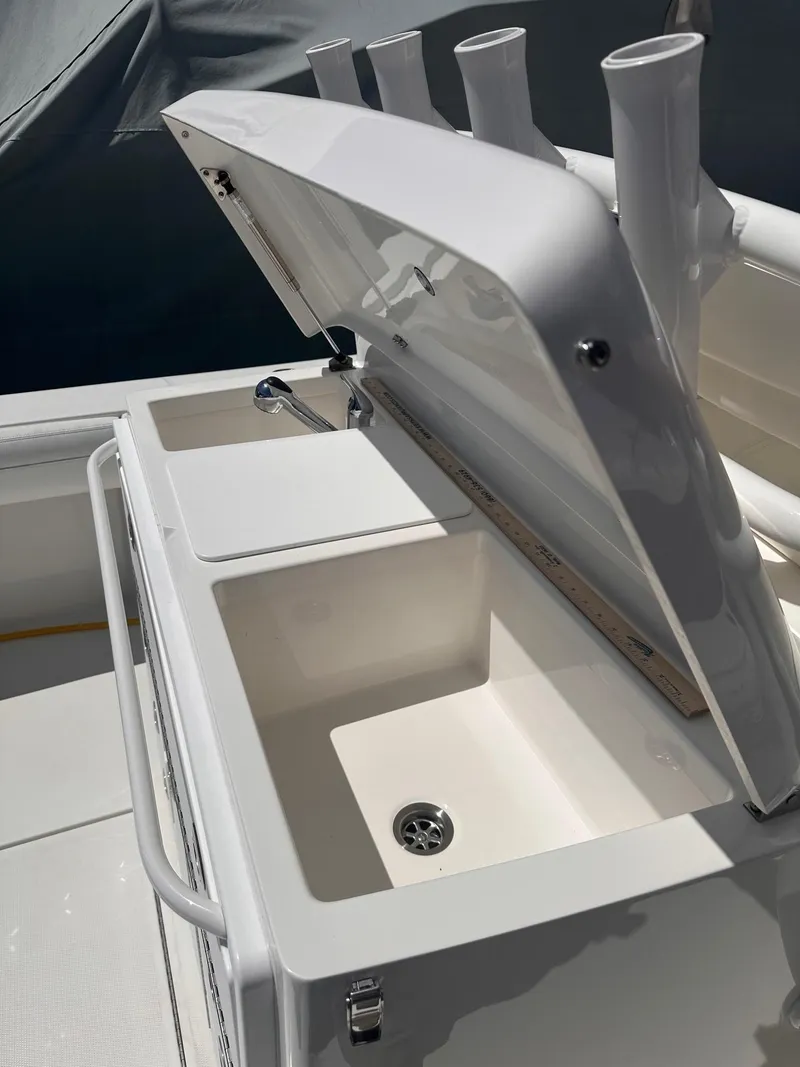 Slide: The Image of 2021 Regulator 34 boat sink and storage area with open lid. - 37