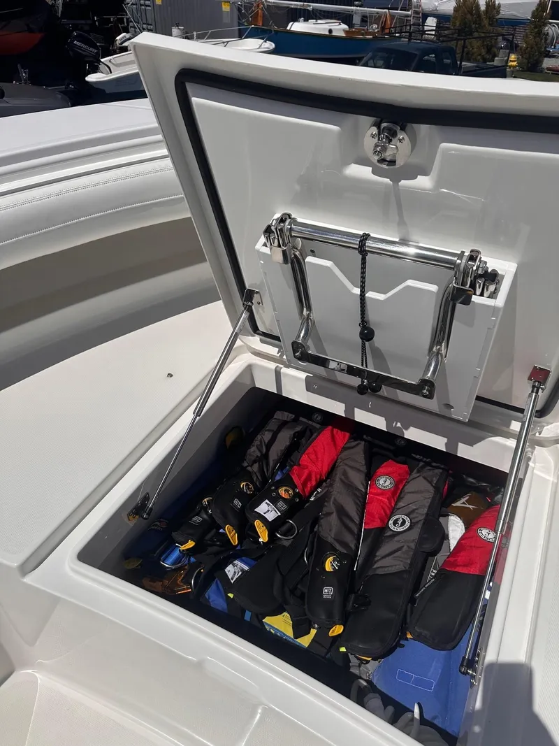 Slide: The Image of 2021 Regulator 34 boat storage compartment with life jackets inside. - 38