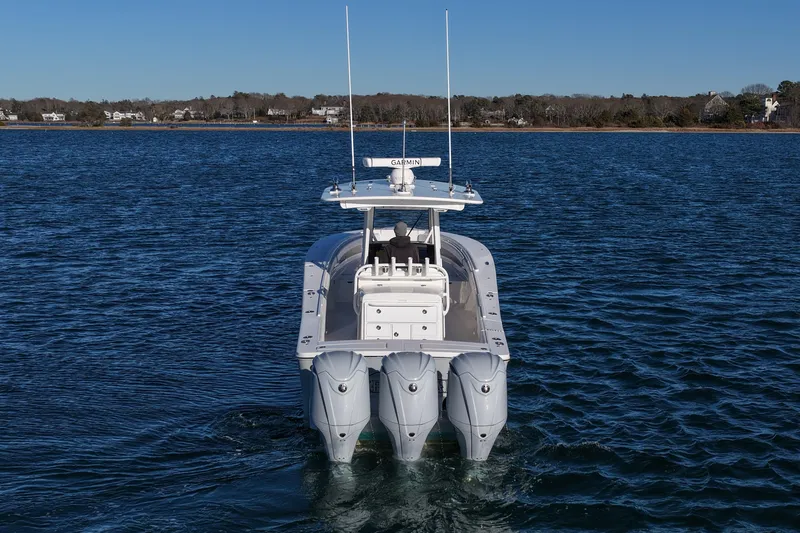 Slide: The Image of 2021 Regulator 34 boat with triple engines on calm water. - 4