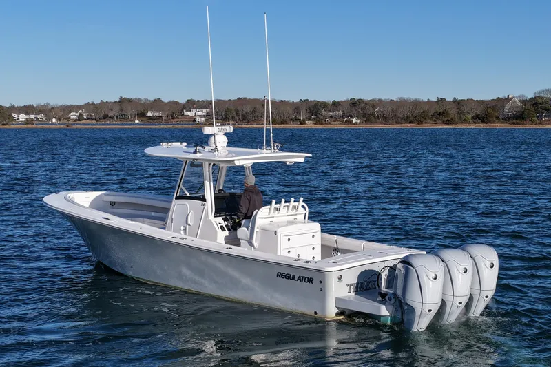 Slide: The Image of 2021 Regulator 34 boat with triple engines on calm water. - 5