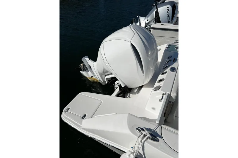 Slide: The Image of 2023 Edgewater 230CC boat with Honda outboard motor on water. - 6