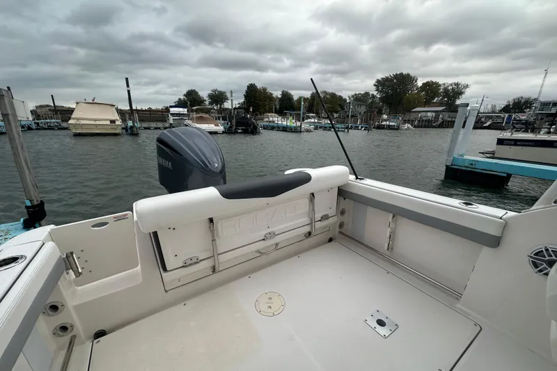 Slide: The Image of 2022 Robalo R247 Dual Console boat docked at marina under cloudy sky. - 14
