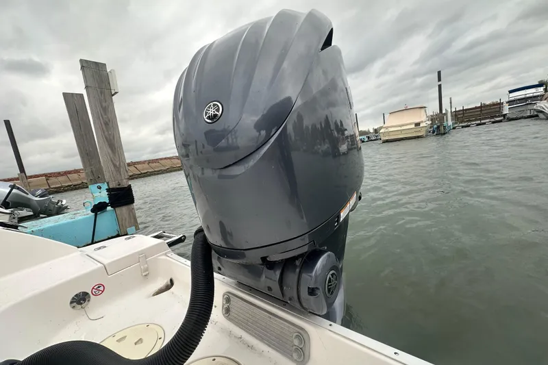 Slide: The Image of 2022 Robalo R247 Dual Console with Yamaha outboard motor at dock. - 16