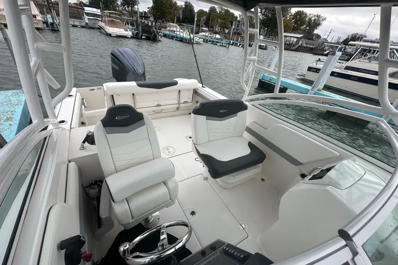 Slide: The Image of 2022 Robalo R247 Dual Console boat interior with seating and steering wheel. - 17