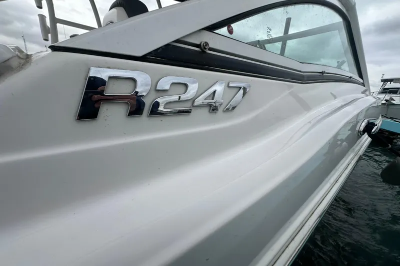 Slide: The Image of 2022 Robalo R247 Dual Console boat side view with logo. - 19