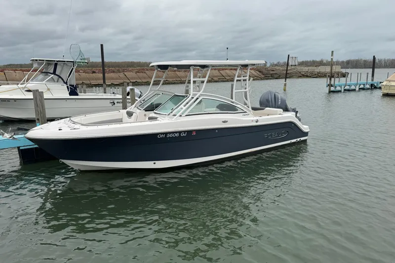 Slide: The Image of 2022 Robalo R247 Dual Console boat docked in a marina. - 3