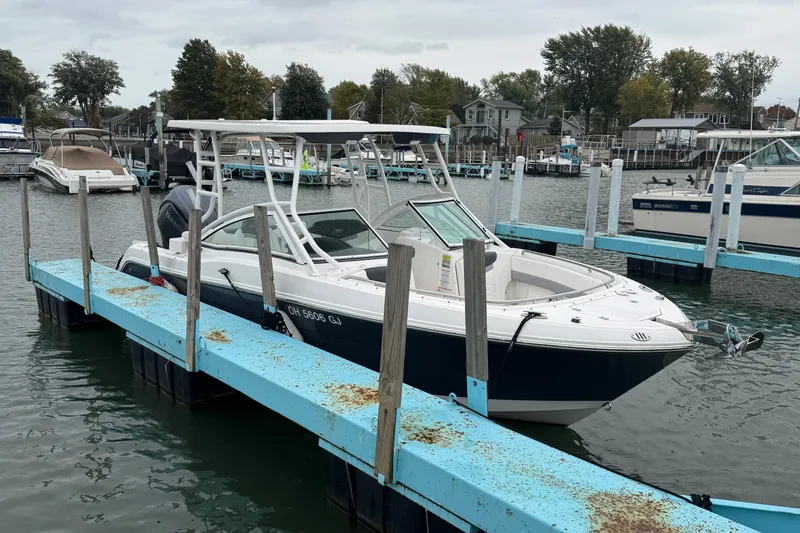 Slide: The Image of 2022 Robalo R247 Dual Console boat docked at marina, overcast sky. - 6