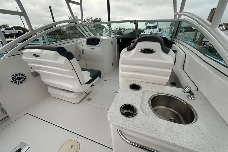Slide: The Image of 2022 Robalo R247 Dual Console boat interior with seating and sink. - 7