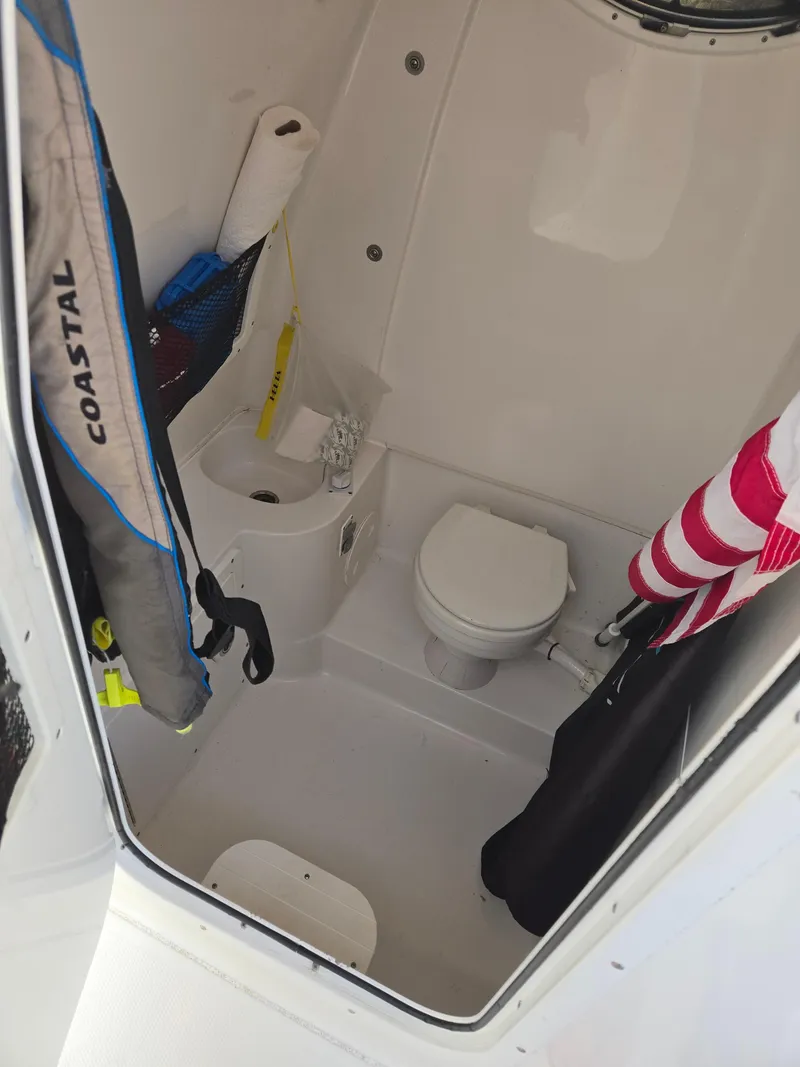 Slide: The Image of 2018 Sea Hunt Gamefish 30 boat interior with toilet and storage area. - 6