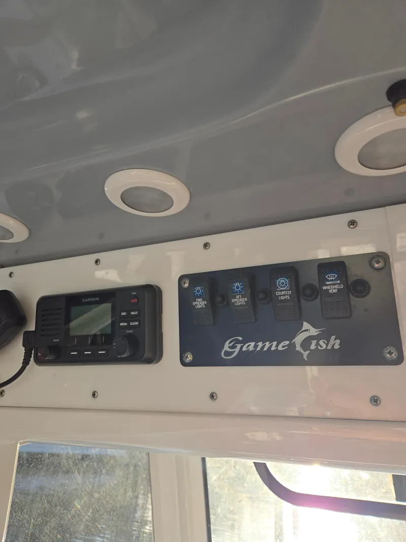 Slide: The Image of Control panel of 2018 Sea Hunt Gamefish 30 with Garmin device and labeled switches. - 7