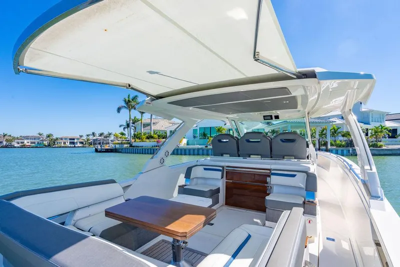 Slide: The Image of 2021 Tiara Yachts 38 LS luxury boat with spacious seating and elegant design on a sunny day. - 12