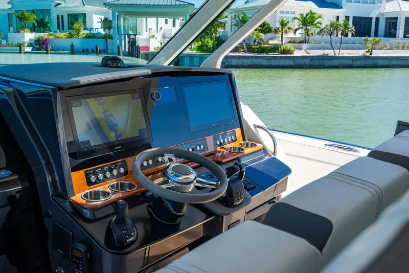 Slide: The Image of Helm of 2021 Tiara Yachts 38 LS with modern navigation displays. - 14