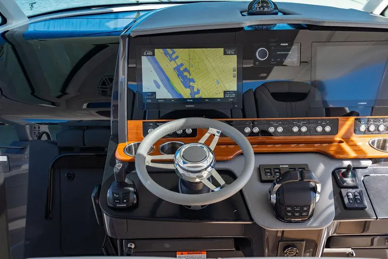 Slide: The Image of 2021 Tiara Yachts 38 LS helm with navigation display and controls. - 15