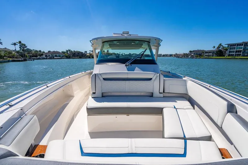 Slide: The Image of 2021 Tiara Yachts 38 LS boat on calm water, featuring spacious seating and sleek design. - 18