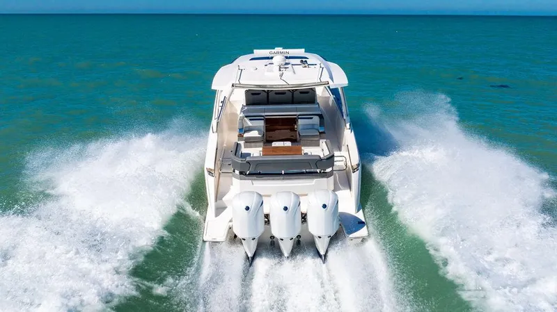 Slide: The Image of 2021 Tiara Yachts 38 LS cruising on open water with powerful engines. - 2