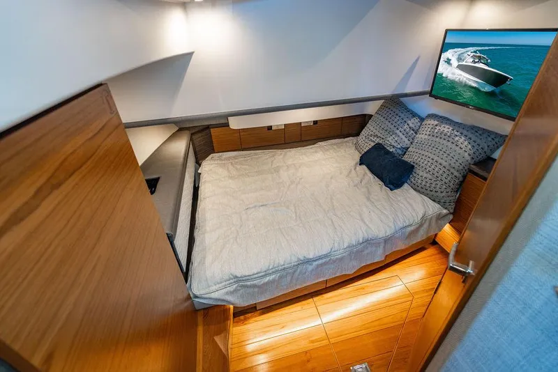 Slide: The Image of 2021 Tiara Yachts 38 LS cabin interior with bed and TV, featuring modern design. - 20