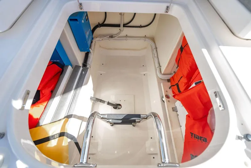 Slide: The Image of 2021 Tiara Yachts 38 LS storage compartment with life jackets and equipment. - 23
