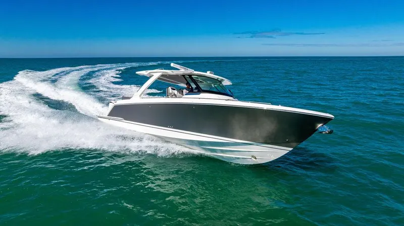 Slide: The Image of 2021 Tiara Yachts 38 LS cruising on open water under clear blue skies. - 24
