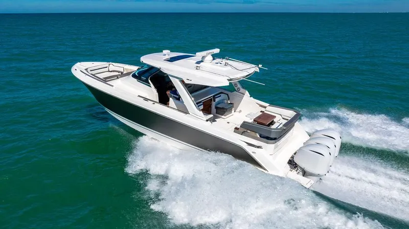 Slide: The Image of 2021 Tiara Yachts 38 LS cruising on open water, showcasing sleek design and powerful engines. - 3