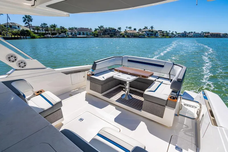 Slide: The Image of Luxurious 2021 Tiara Yachts 38 LS with elegant seating, cruising on serene waters. - 4