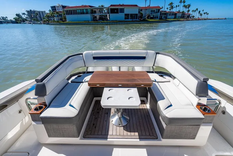 Slide: The Image of 2021 Tiara Yachts 38 LS luxury seating area with table on calm water. - 5