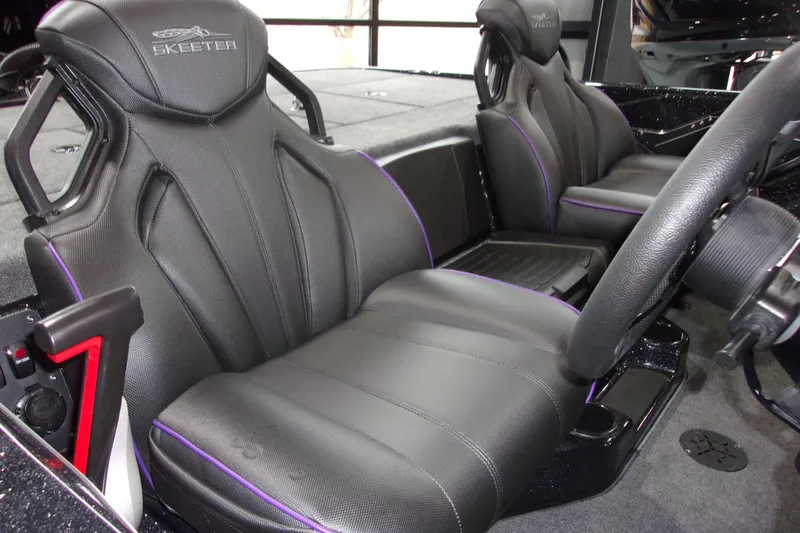 Slide: The Image of 2025 Skeeter ZXR21 boat interior with black leather seats and purple accents. - 10